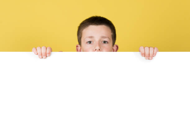 istock Cute boy hidden behind white billboard 1407449370