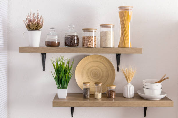 istock Front view of stylish open kitchen shelves with various eco-jars under bulk products. proper storage and beautiful decor in a modern kitchen. 1407449570