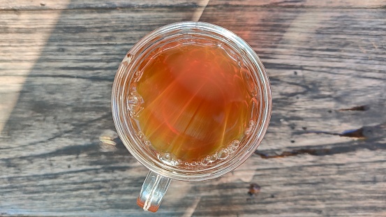hot brown tea drink in a glass as seen from above