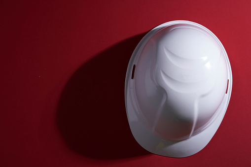 white hard hat on red background