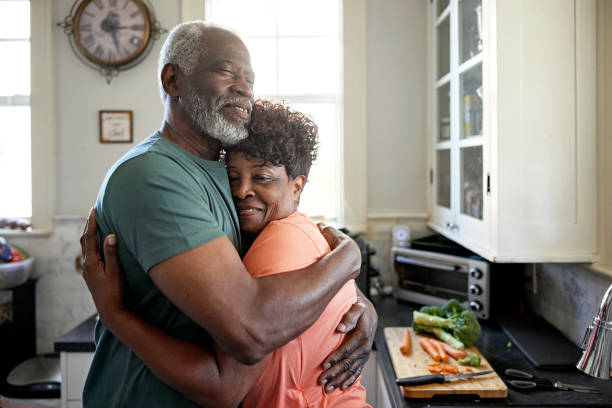 istock Seniors taking a break from preparing food to embrace 1407450706