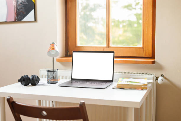istock Modern home office working space with laptop computer mockup. Remote work outside the office concept 1407451010