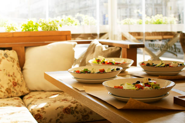 a table with healthy salads in a summer cafe in the city center