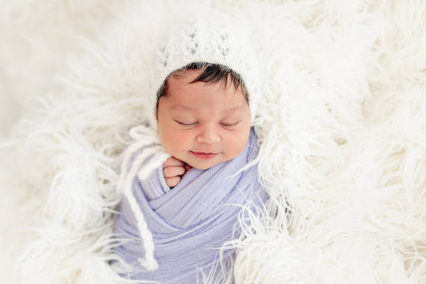 istock Smiling newborn in knitted hat 1407451281