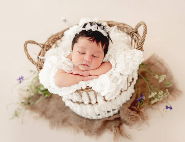 istock Funny newborn in basket on stomach 1407451294
