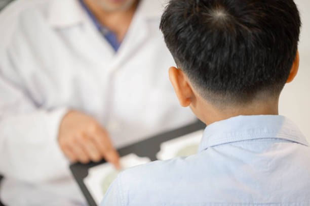 istock Selective focus of Boy doing eye test checking examination with optometrist in optics store, Optometrist doing color blindness disease perception test in optical shop 1407451297