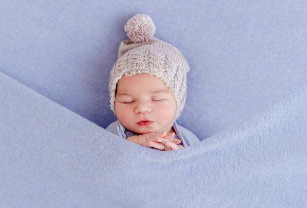 istock Adorable sleeping newborn covered with blanket 1407451980