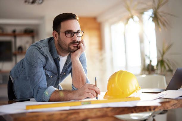 istock Thoughtful building contractor brainstorming while working at home office. 1407452161