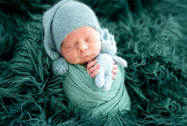 istock Lovely newborn in green knitted hat 1407452250