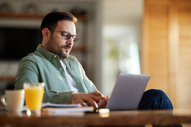 istock Young businessman working on a computer at home. 1407453712