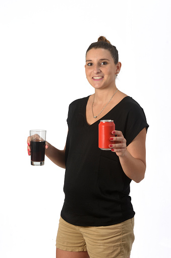 woman holding a glass of coke soda on white background