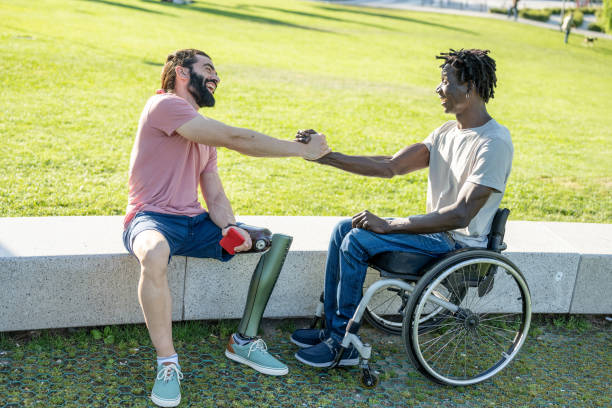 Multiracial people greeting each other, happy friends with disability having fun at park city Multiracial people greeting each other, happy friends with disability having fun at park city polio virus photos stock pictures, royalty-free photos & images