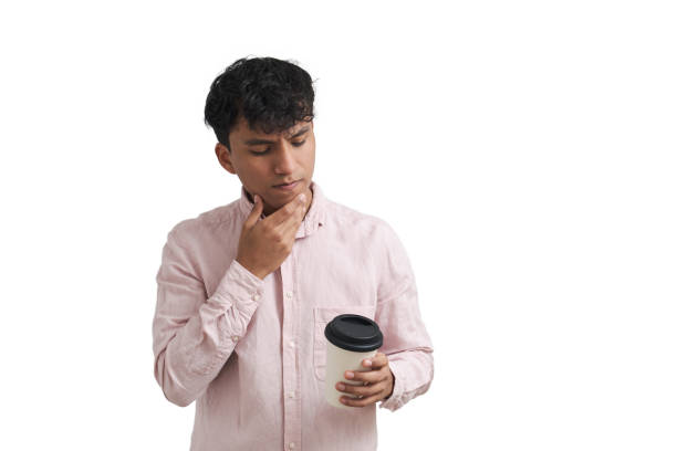 istock Young peruvian thinking looking at a cup of coffee, man isolated. 1407459312