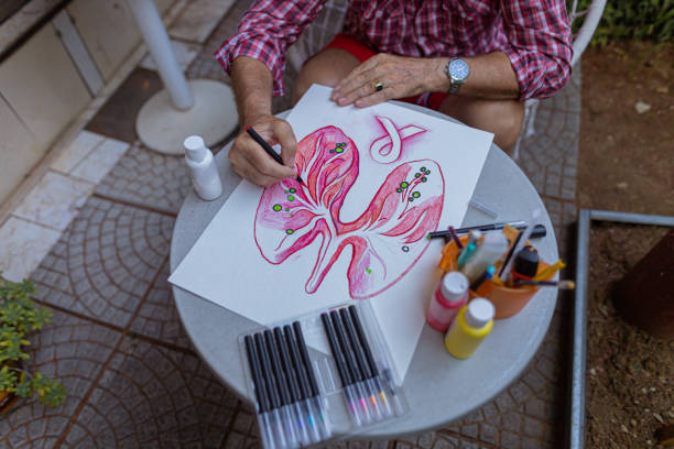 istock Senior drawing lungs and cancer for raising awareness 1407461975