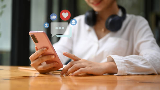 istock Smiling young woman using mobile phone for sharing and commenting in online community. 1407466659