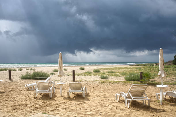 colorful beach baskets on an idyllic golden sand beach on the German Wadden Sea coast under an expressive sky