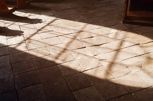 Sunlight on the stone floor in church, the contour of the window