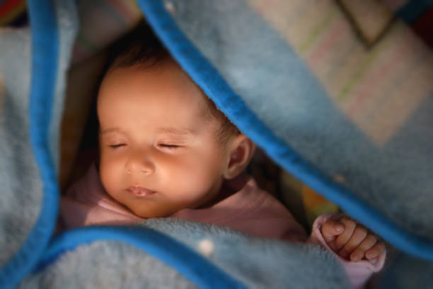 Newborn baby sleeping in blanket during winter season.