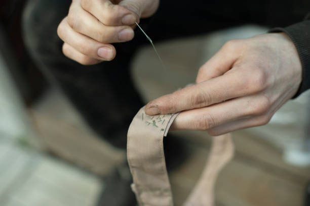 istock Sewing tape. Collar stitching in army. Work of weaver. 1407470028