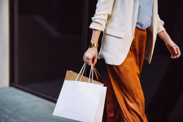 Close Up Photo Of Woman Hands Holding Shopping Bags Outdoors Unrecognizable businesswoman carrying paper bags while walking at the city street. shopping bag stock pictures, royalty-free photos & images