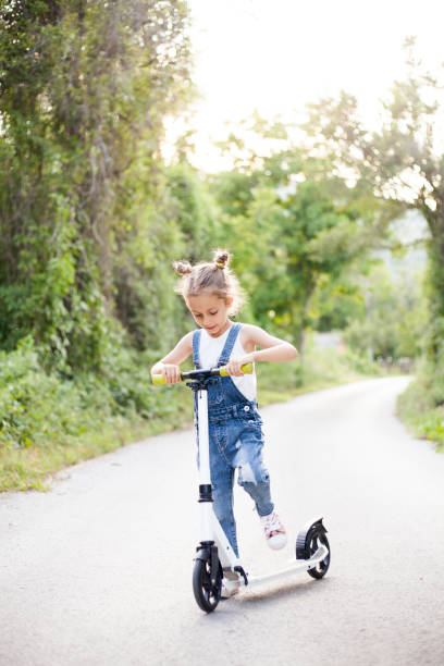 istock girl with push scooter 1407472027