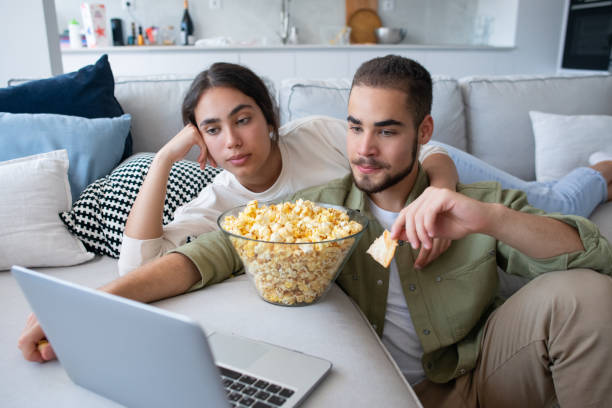 istock Content couple eating popcorn and watching movie 1407477519