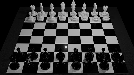Chess board with black and white chess pieces populating the starting positions of a fresh game