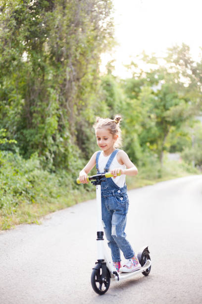 istock girl with push scooter 1407480071
