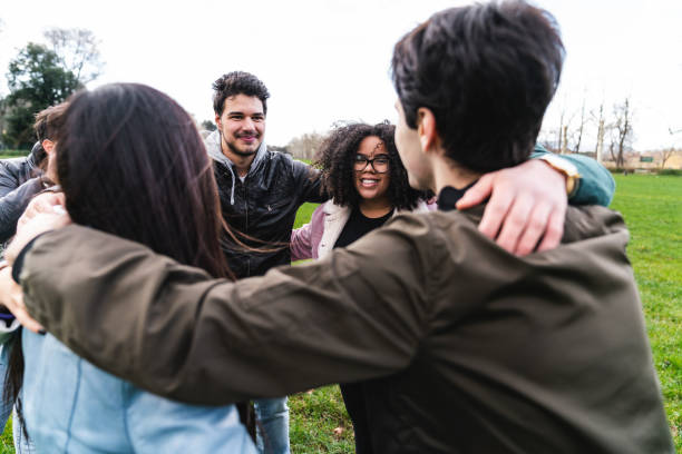 istock Multi ethnic group of friends embracing together, showing unity 1407480178