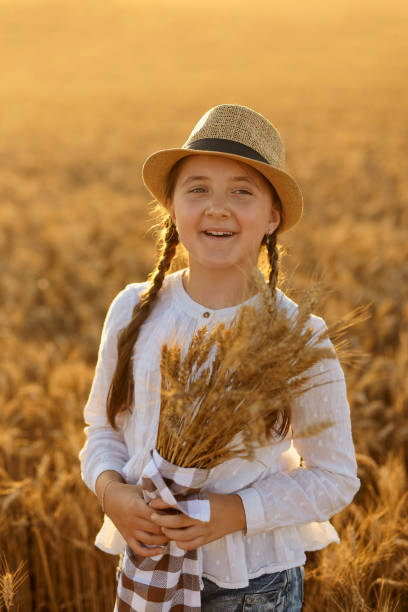 istock Girl holding ears of corn in her hands. 1407486014
