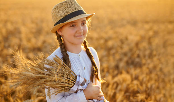istock Girl holding ears of corn in her hands. 1407486038