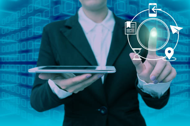istock Lady in suit holding tablet symbolizing successful teamwork accomplishing newest project plans. Woman carrying electrical device representing combined effort management. 1407486822