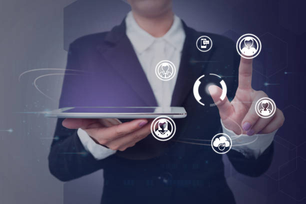 istock Lady in suit holding tablet symbolizing successful teamwork accomplishing newest project plans. Woman carrying electrical device representing combined effort management. 1407486907