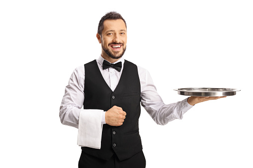 Smiling waiter with an empty tray on his hand isolated on white background