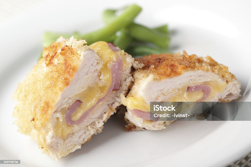 Schnitzel Cordon bleu Chicken schnitzel Cordon blue with green beans on white plate closeup Cordon Bleu - Meal Stock Photo