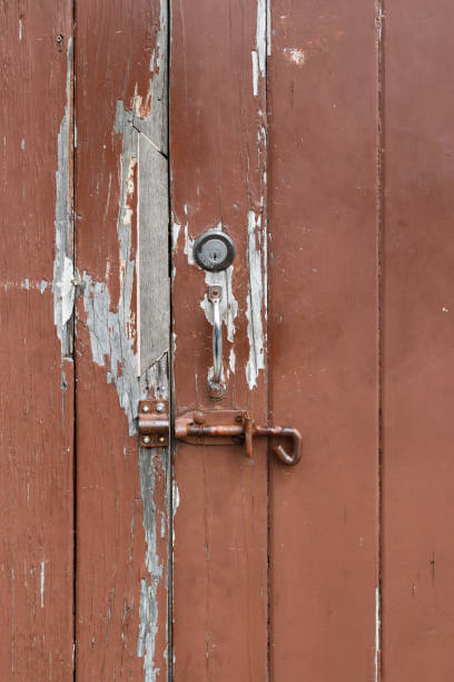 istock Rusty bolt fastener on an old wooden door 1407487658