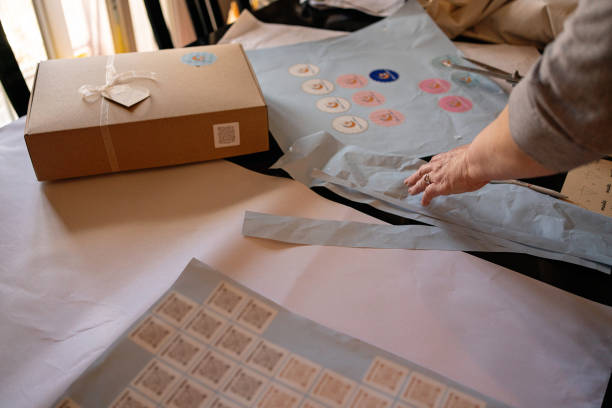 istock Sales woman is cutting stickers for delivering package 1407488440