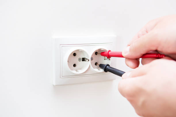 istock Measuring the voltage in the socket with a professional digital multimeter. Profession electrician, the process of installing sockets. Close-up, selective focus, noise. 1407489176