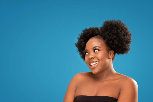 istock Smiling beauty afro woman posing in studio. 1407491708