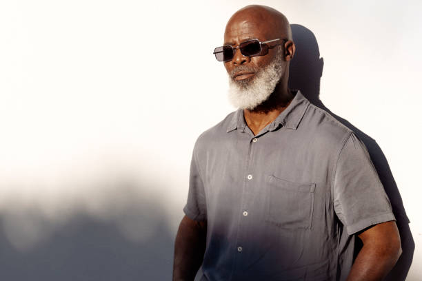 istock Handsome senior man standing outside in the afternoon sun 1407492170
