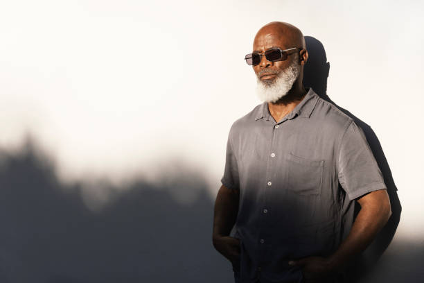 istock Handsome senior man standing outside in the afternoon sun 1407492181