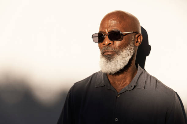 istock Handsome senior man standing outside in the afternoon sun 1407492205