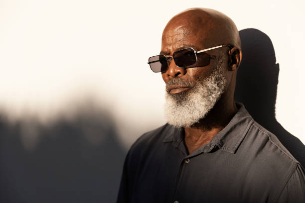 istock Handsome senior man standing outside in the afternoon sun 1407492268