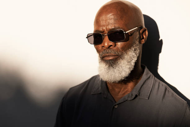 istock Handsome senior man standing outside in the afternoon sun 1407492269