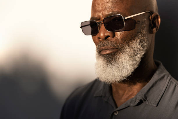 istock Handsome senior man standing outside in the afternoon sun 1407492279