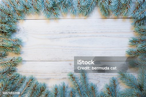istock Fir branches new year frame on wooden background, top view, copy space 1407493208
