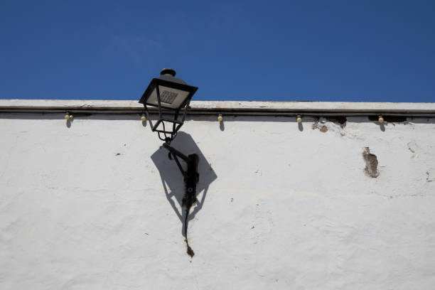 istock Lantern on the white wall and blue sky 1407493234