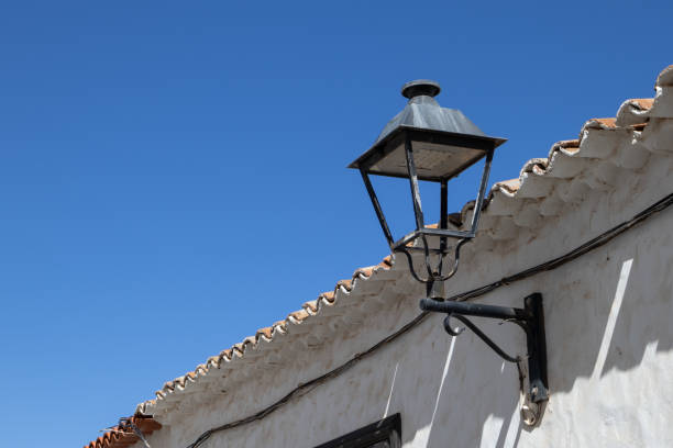 istock Lantern on the white wall and blue sky 1407493238