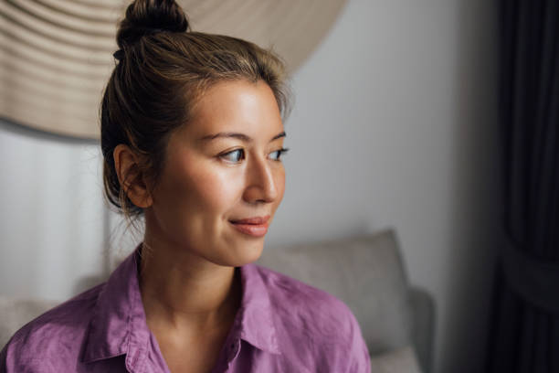 istock A Beautiful Woman Looking Away While Sitting At Home And Relaxing 1407494938