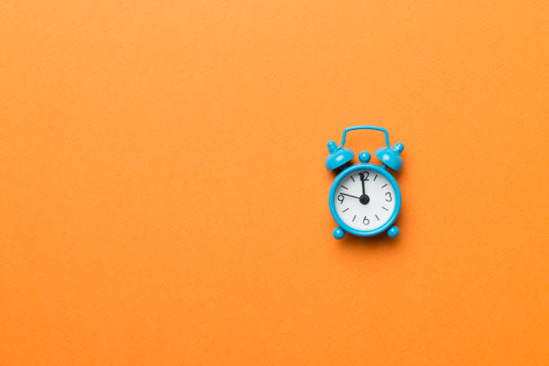 istock Alarm clock isolated on colored background with copy space top view 1407496658